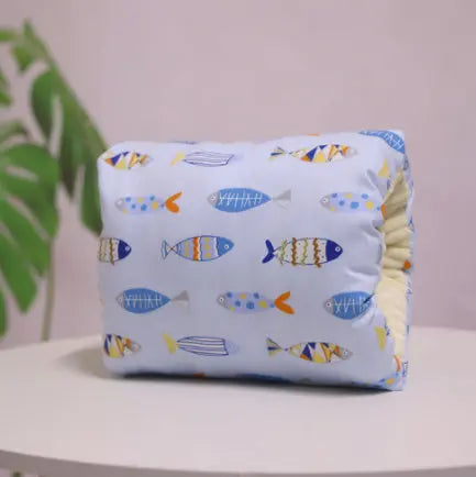 Cushion with a fish pattern on a white surface