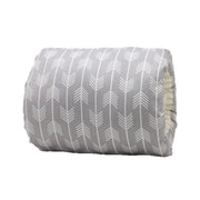 Roll of gray fabric with a white arrow pattern on a white background