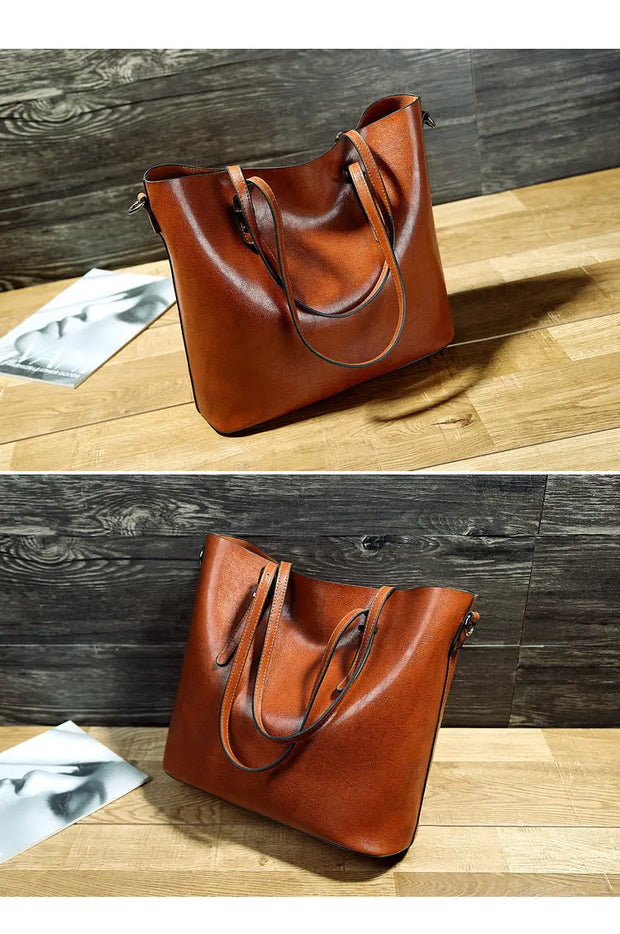 Brown leather handbag on a wooden surface with a gray wooden background