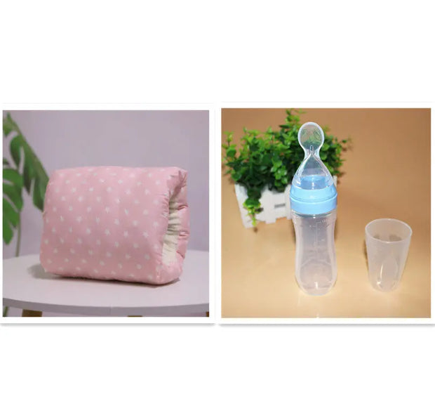 Pink polka dot pillow and clear baby bottle with blue cap on a beige surface.