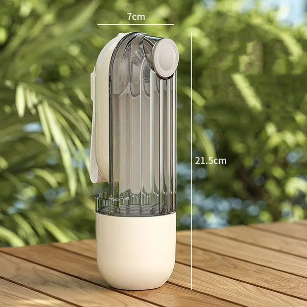 Transparent spray bottle with beige base on a wooden surface, with measurements indicated.