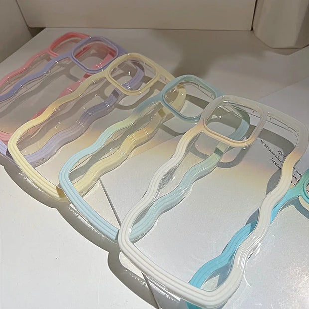 Set of clear plastic hangers with colorful clips on a white surface