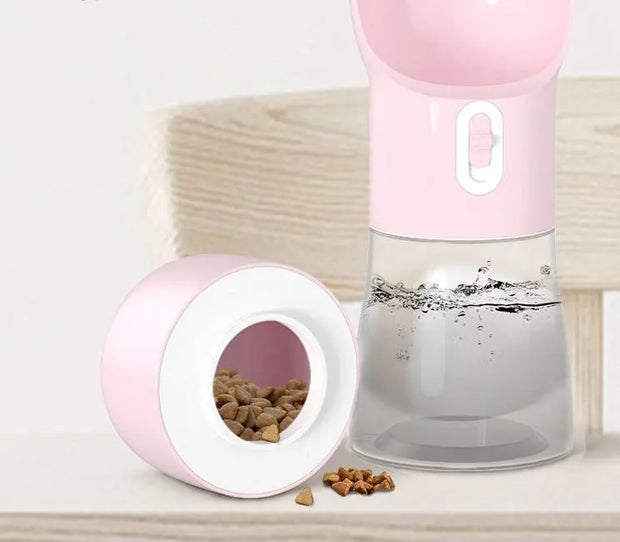 Traveling Out Portable Dog Water Dispenser in pink with separate compartments for water and food.