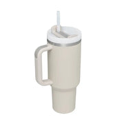 Beige insulated mug with handle and straw lid on a white background