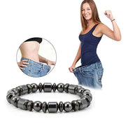 Woman wearing a blue tank top and jeans with a close-up of a black beaded bracelet on a white background.