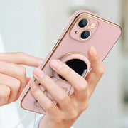 Phone case with ring holder held by a hand against a light background