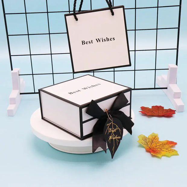 Gift box with 'Best Wishes' tag and black ribbon on a blue background