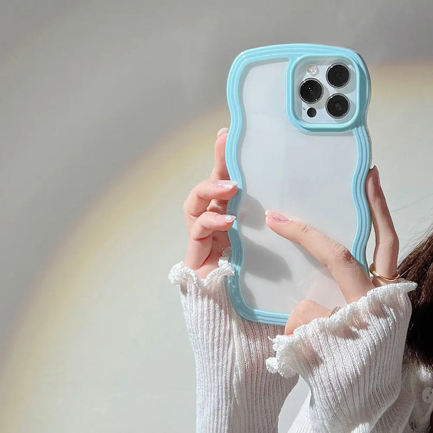 Person holding a phone with a blue case against a neutral background