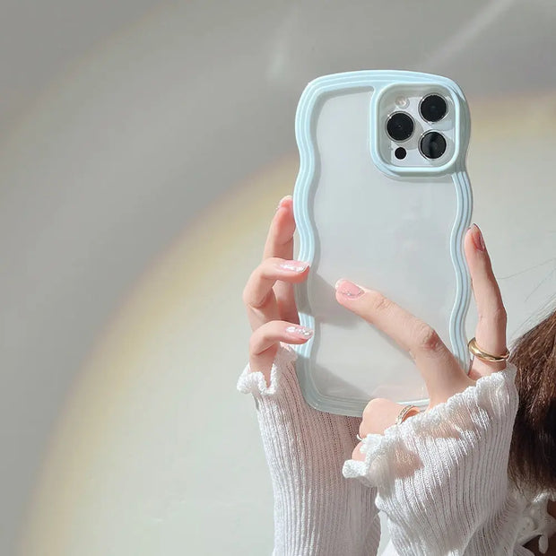 Person holding a phone with a clear case against a neutral background