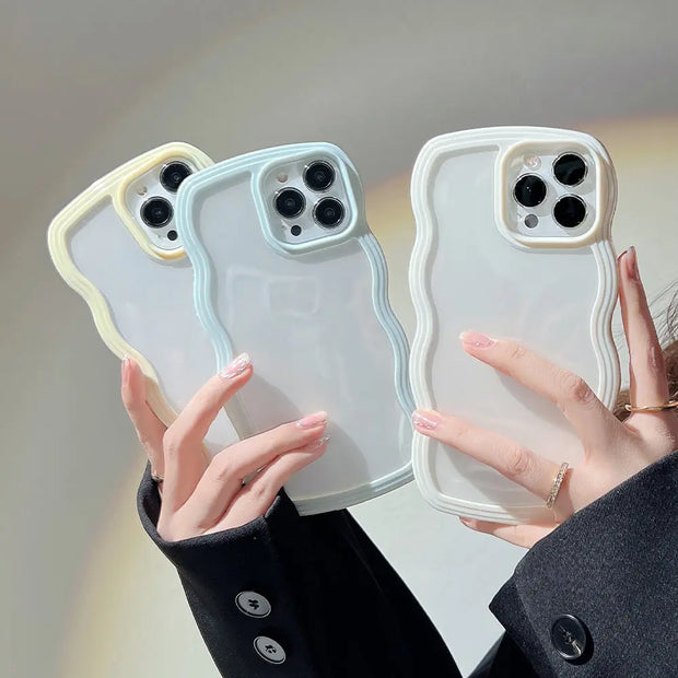 Three phone cases held by a person against a neutral background